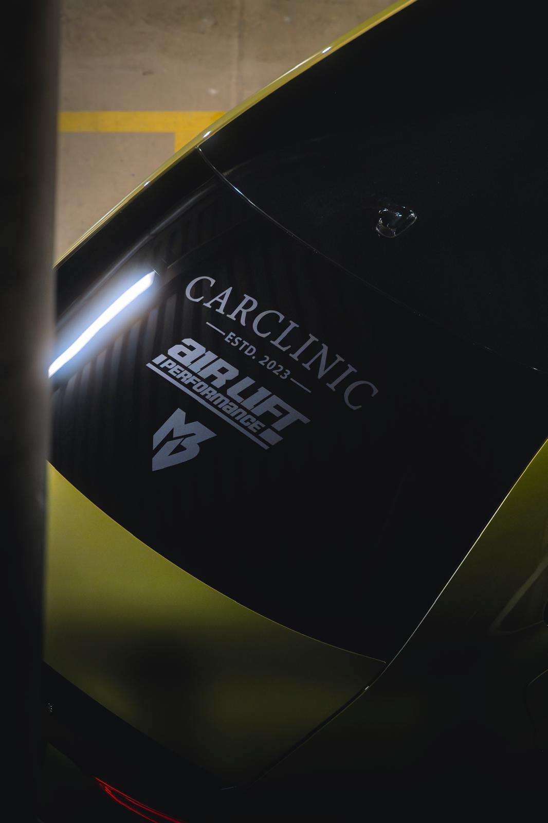lowered black sports car at night with dramatic lighting, professional automotive photography, dark moody atmosphere